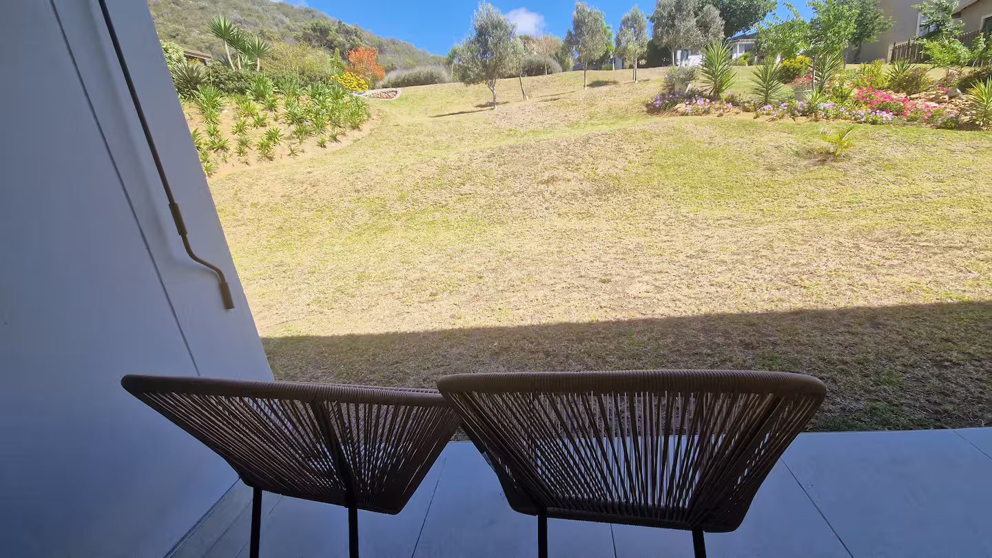 Outdoor area with grass and hills view